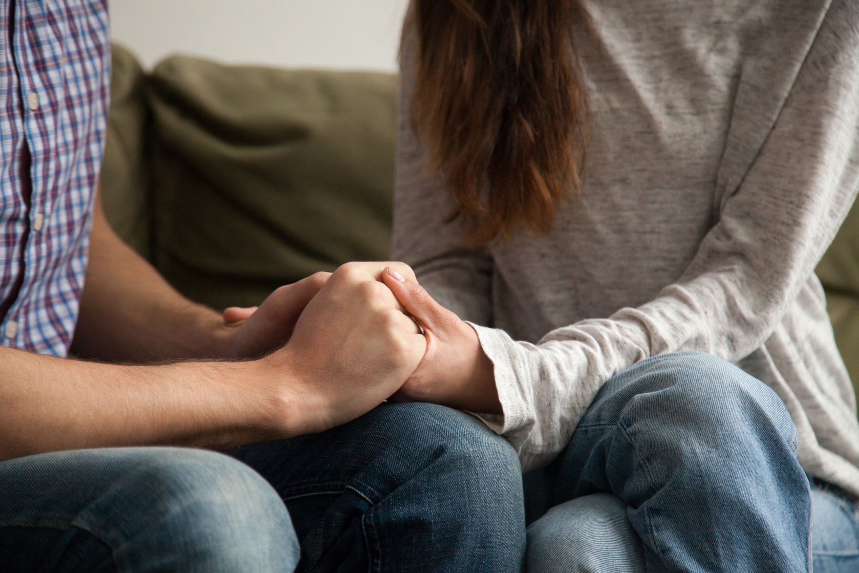couple holding hands in counseling